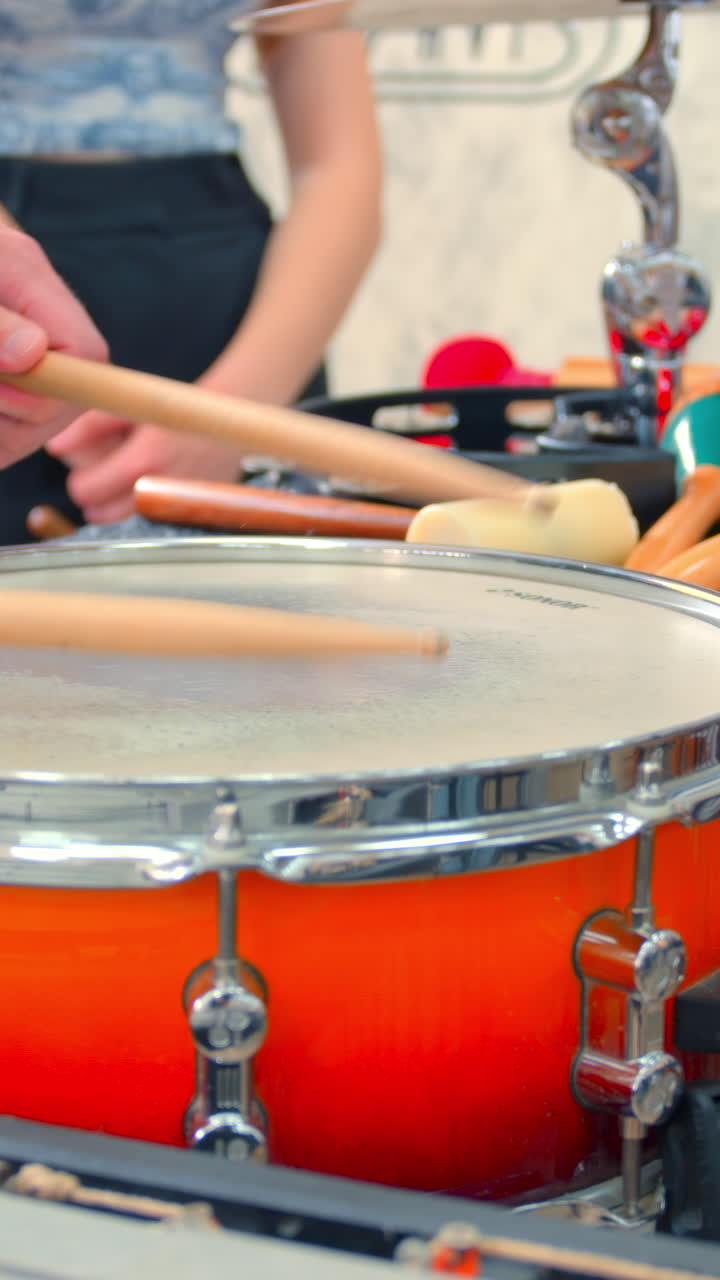 Close-up of Hands Playing a Snare Drum with Drumsticks