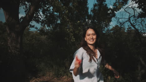 woman playing with water gun in a forest