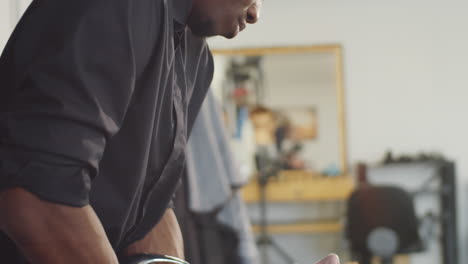 black barber washing hair of male client