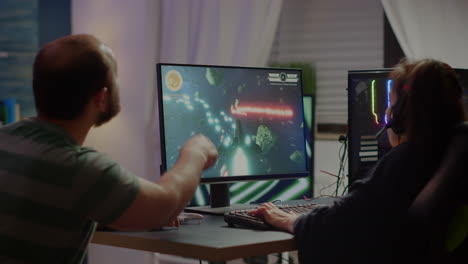 gaming over for nervous pro couple gamers, playing space shooter