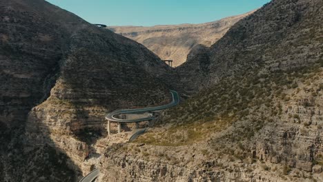 cinematic long shot of mountain road - fort munro, pakistan