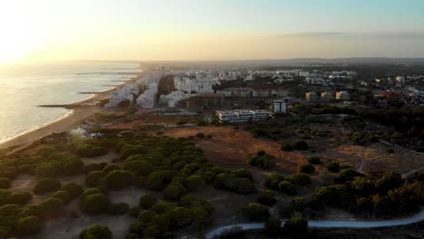 Aerial-view-of-Quarteira-city-in-ALgarve,-portugal,-at-sunset