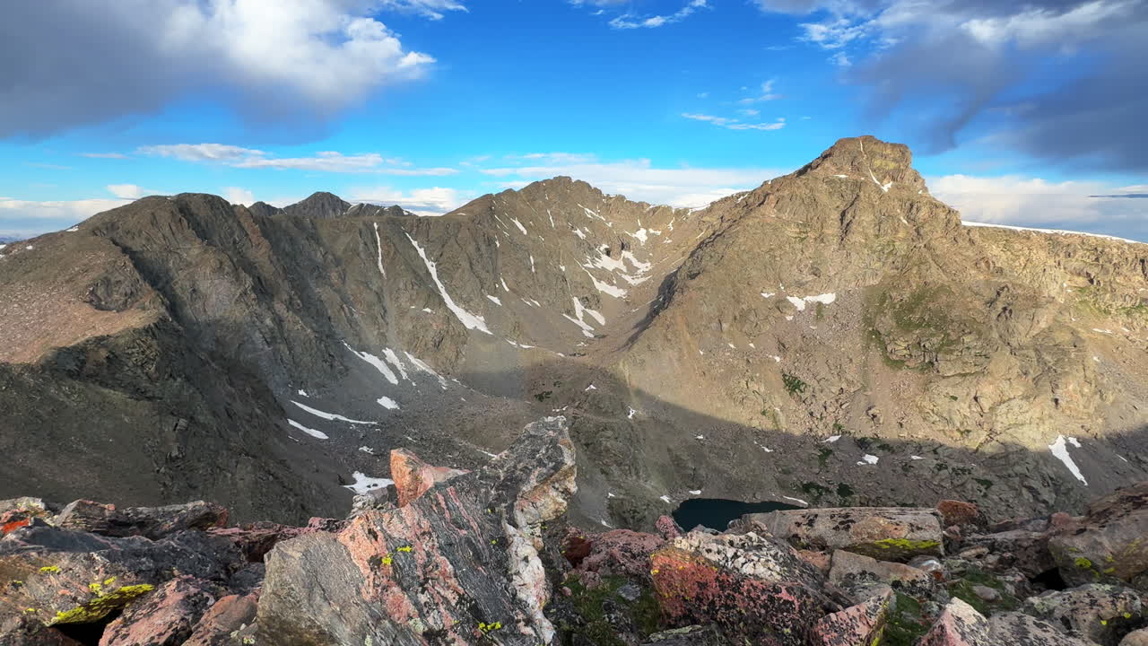 Halo Ridge Notch Mountain Shelter trail view of Mount of the Holy Cross Ridge saddle Peak 14er Colorado Sawatch Rocky Mountains Tear of Bowls Lake early morning sunrise vibrant blue skies clouds pan
