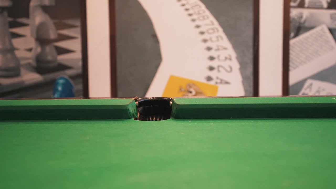 Snooker billiard table shot sinking green six ball with white cue ball