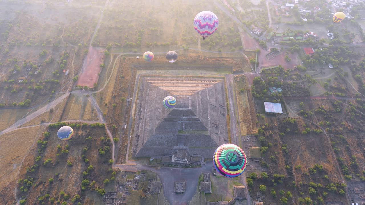 Teotihuacan pyramids seen from hot air balloon at sunrise, epic aerial video of ancient Mesoamerican ruins near Mexico City.
