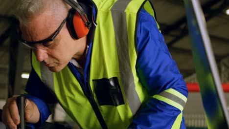 engineer repairing aircraft engine in hangar 4k