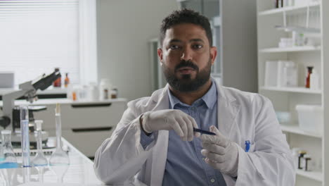 scientist explaining ideas to camera during video call in laboratory