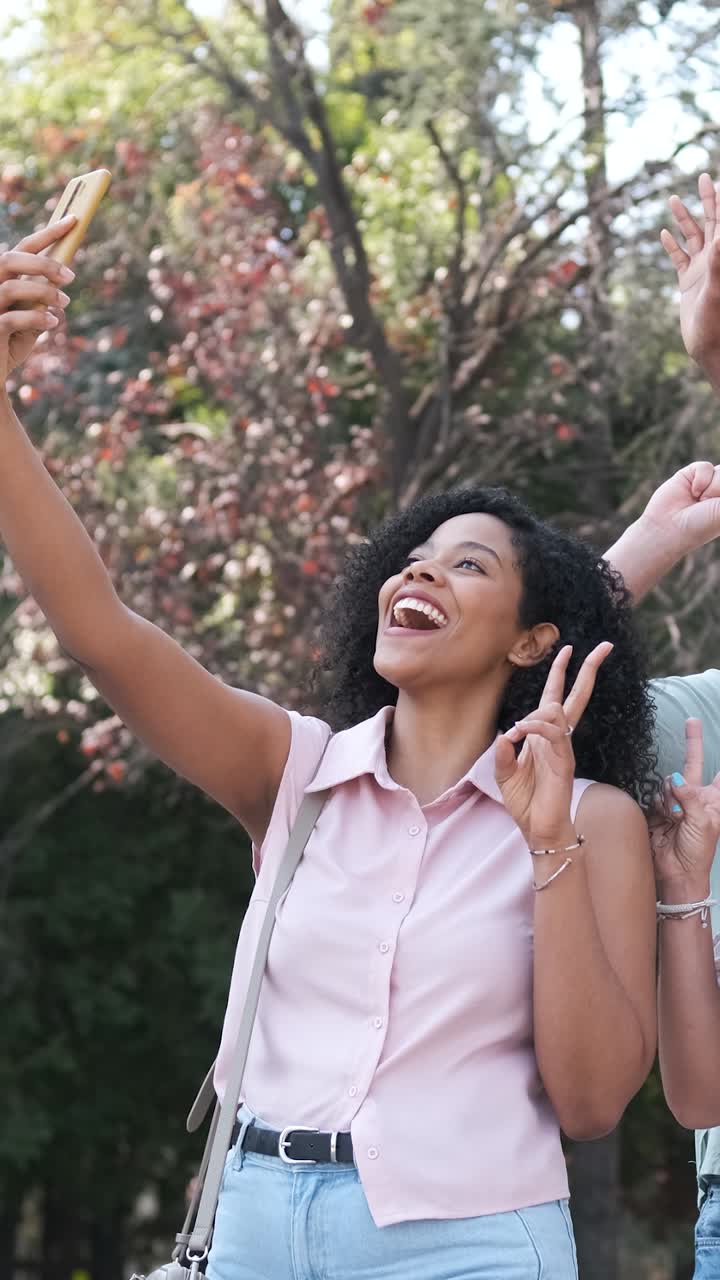 Happy multiethnic friends taking self-portrait in city during sunny day