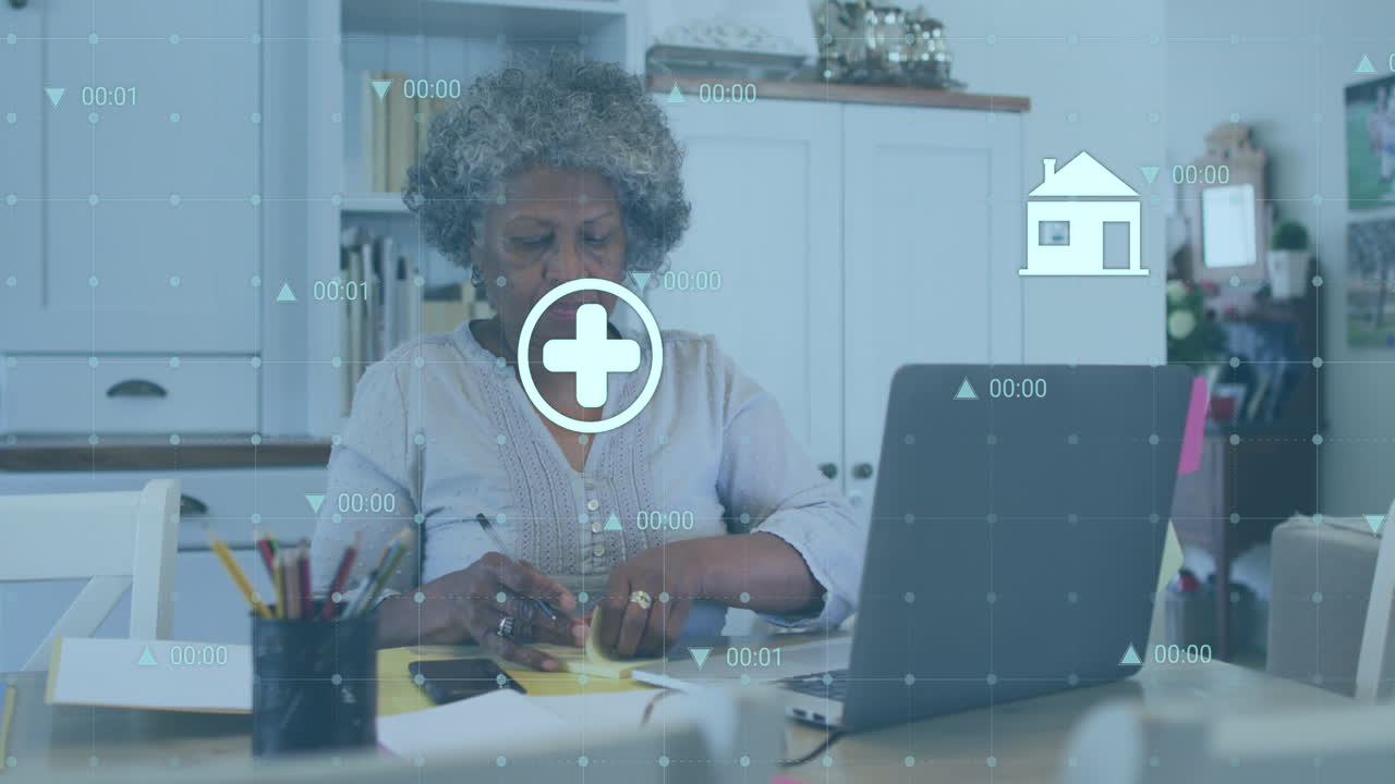 Animation of data processing over senior african american woman using laptop
