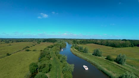 Aerial-Drone-Footage-of-a-boat-along-the-River-Waveney,-Norfolk