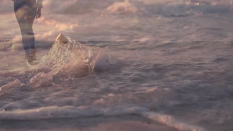 woman walking at the beach and a letter in a bottle