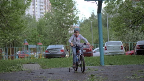 child having active outdoor leisure with riding a bike