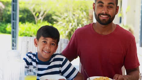 Happy-father-and-son-having-breakfast-4k