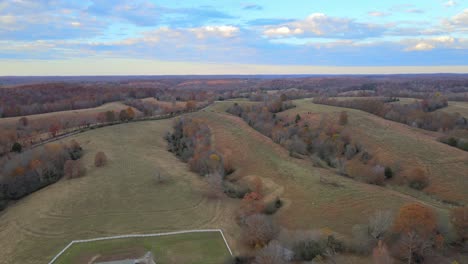 aerial pan of a beautiful tennessee countryside with a beautifully colored sky in the background