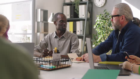 Multiethnic-Male-Colleagues-Talking-at-Office-Meeting