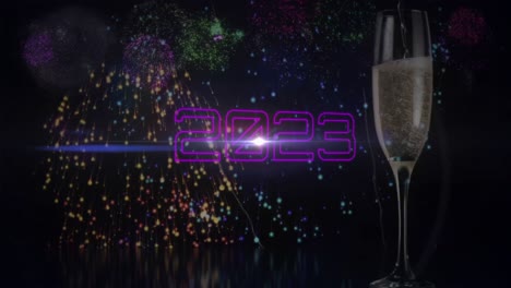 animation of 2023 text with glass of champagne over fireworks on black background