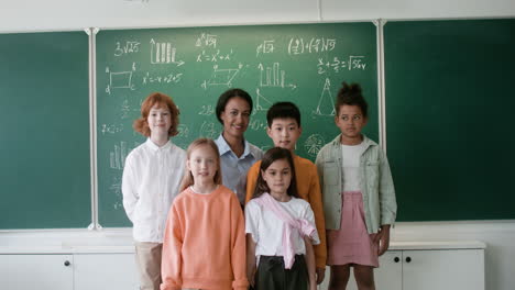 Teacher-and-pupils-posing-for-camera.