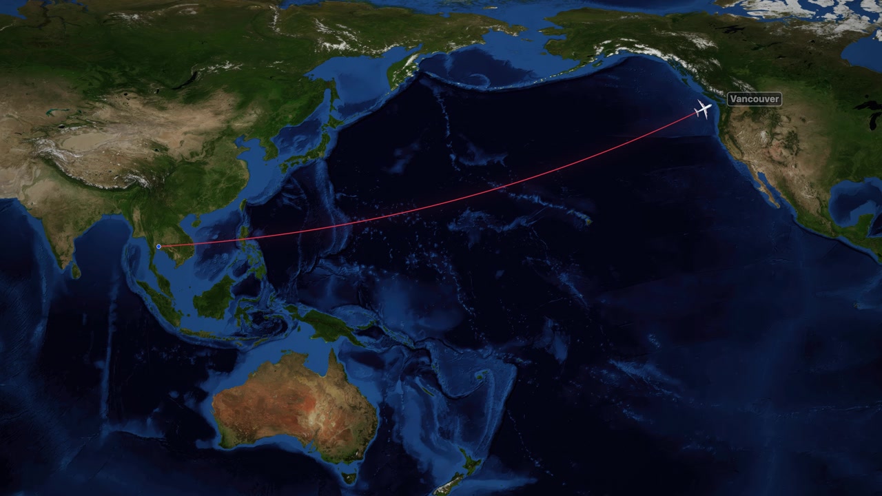 Digital world map shows a commercial airplane flying from Bangkok to Vancouver across the Pacific