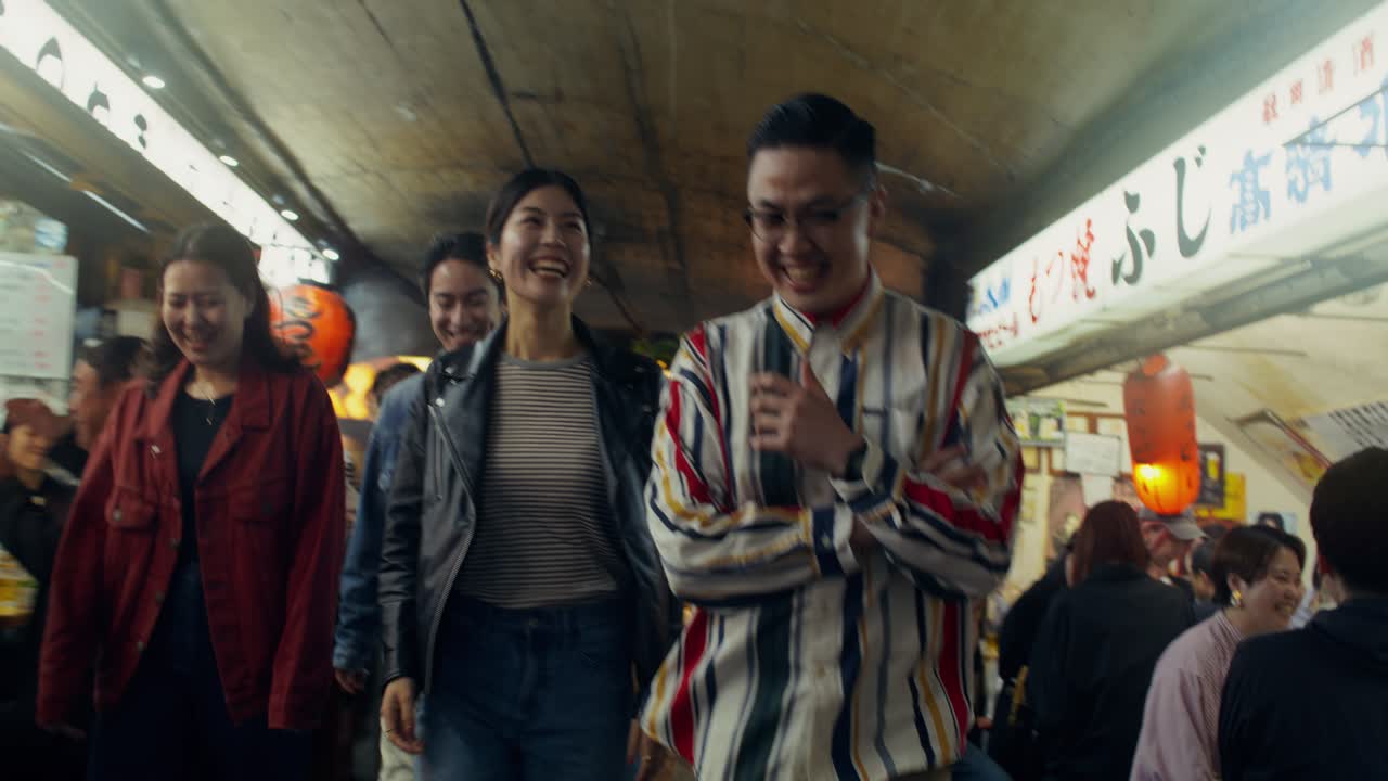 Friends enjoying a night out in a Japanese market