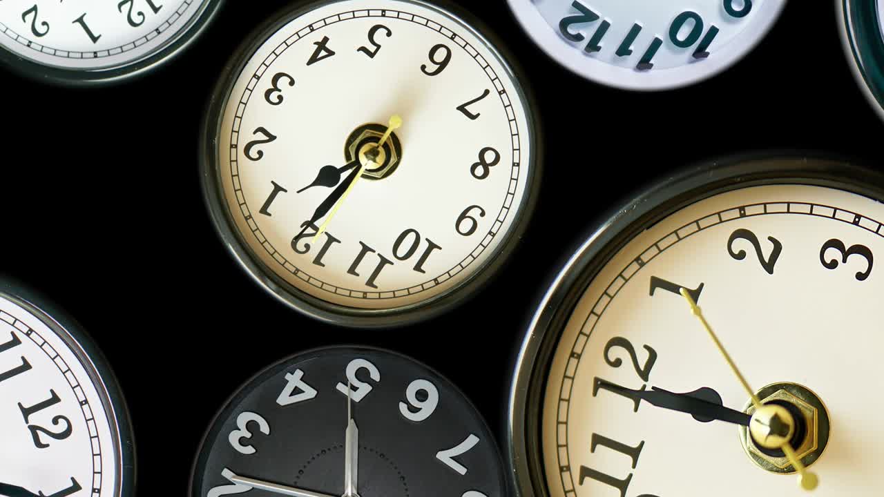 Many time lapse clock faces appear at zoom out all showing different  time. Various clocks in timelapse, busy time flow concept. 4k.
