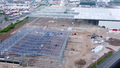 incomplete industrial building construction site steel framework aerial view zoom in