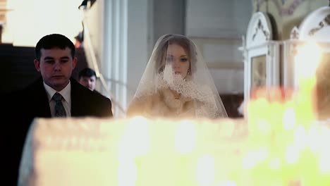 newlyweds in the church facing candlestick