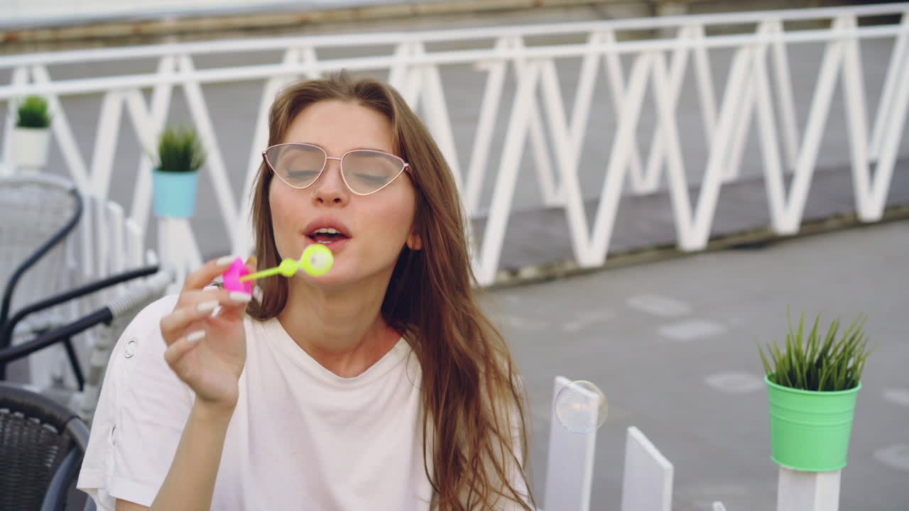 야외에서 거품을 불어넣는 여자