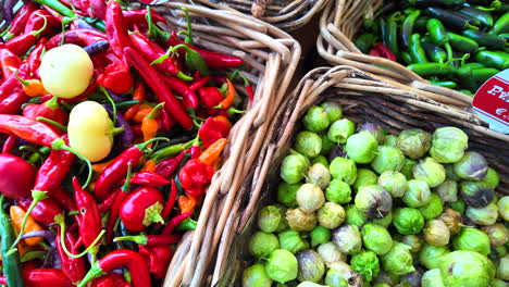 spicy chilli peppers, jalapeño peppers and green tomatillos, fresh vegetables from the local farm for sale at an organic farmers market, healthy bio greens, 4k shot