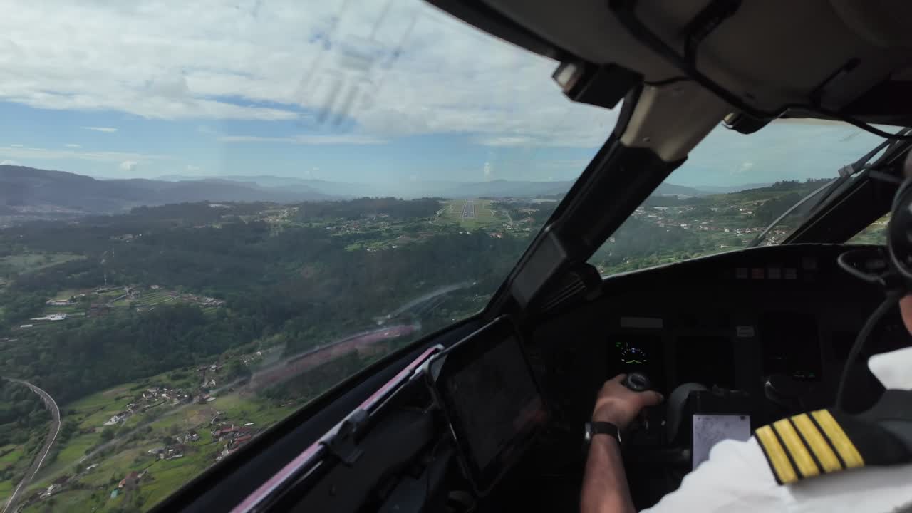 Caucasian Pilot (Captain Seat), flying manually a jet airplane during the intermediate approach to Vigo airport runway