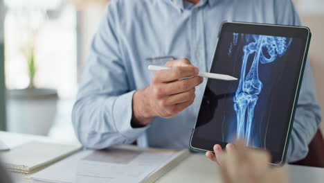doctor reviewing x-ray of patient's knee and hip