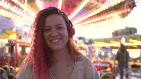 woman listening to music with headphones and fair background