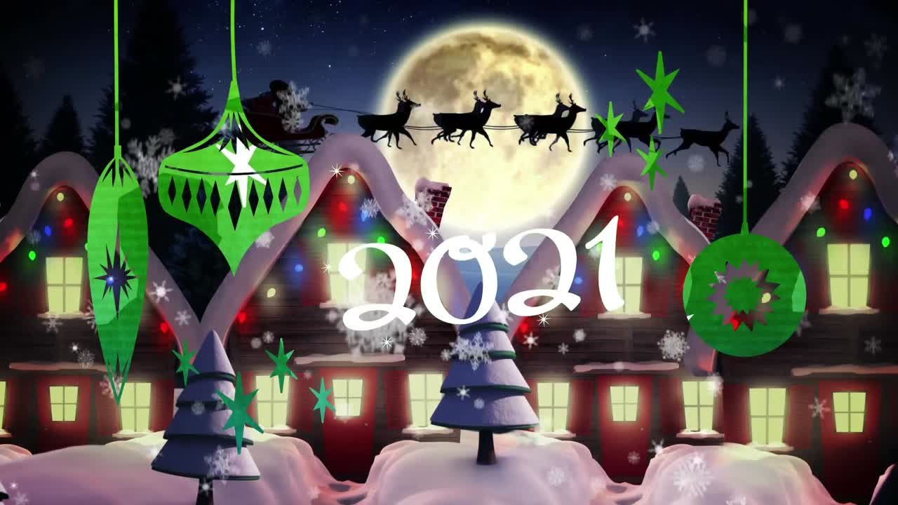 2021년 텍스트와 크리스마스 장식품이 겨울 풍경 위에 내리는 눈에 매달려 있습니다.