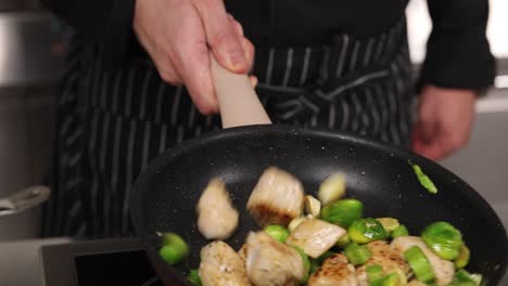 chef cooking chicken and vegetables