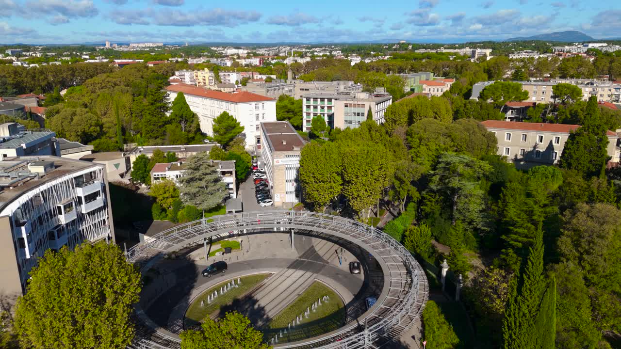 Aerial view of an educational building in the south of France, part of a university campus, combining modern architecture with natural surroundings, symbolizing academic growth and innovation.