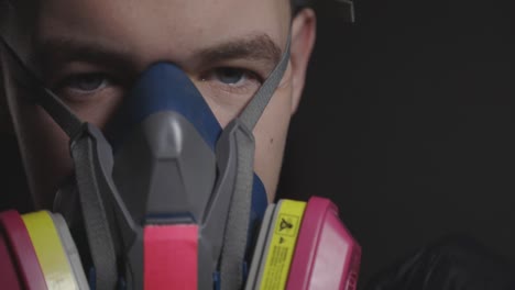 Putting-on-a-respirator-to-help-with-breathing-and-filtering---close-up