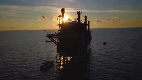 Stunning-aerial-flight-at-beautiful-sunset-over-oil-platform-in-Mabul,-Malaysia