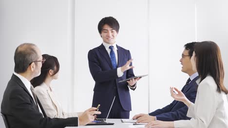 asian businessman explaining at a meeting