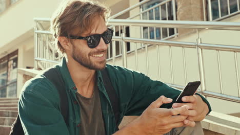 man using smartphone on stairs