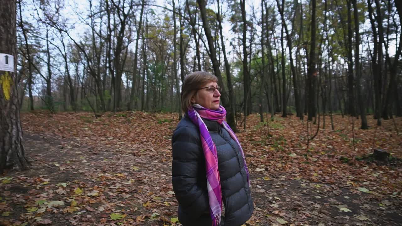 Woman walking in a forest in autumn
