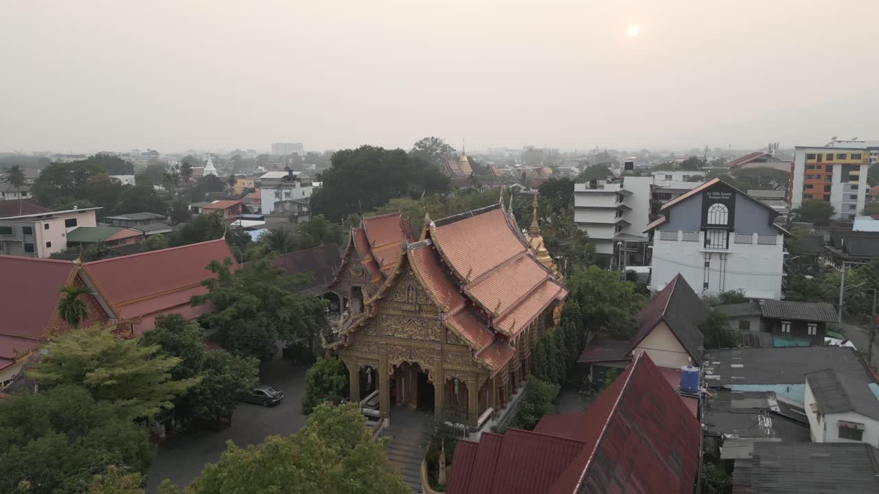 Panoramic Aerial View of a Traditional Buddhist Temple in a Hazy Urban Landscape