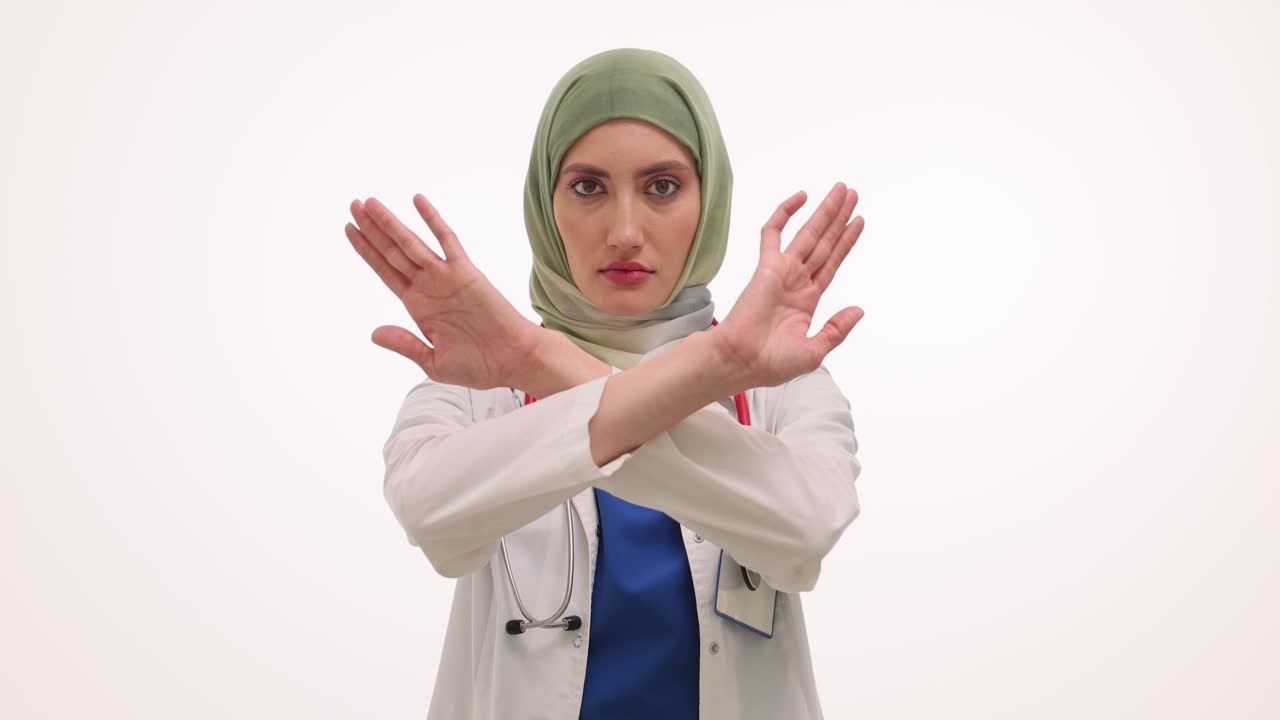 Female Doctor in Hijab Making a Stop or No Gesture with Crossed Arms