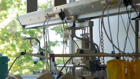 hospital intensive care room with medical equipment for patients, healthcare equipment, sunny day outside, distant medium shot