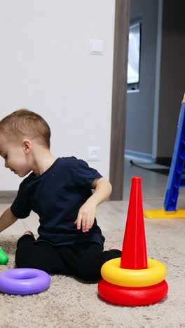 small playground indoor for boy. toddler funny active kid playing with toys. vertical video