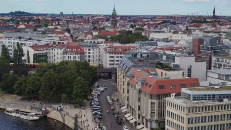 Rooftops-of-berlin-with-passing-tram-and-city-train