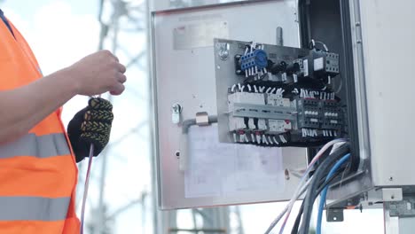 electrical engineers inspect the electrical systems at the equipment control cabinet