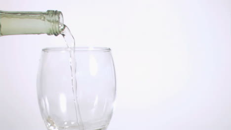 white wine flowing in super slow motion from a bottle