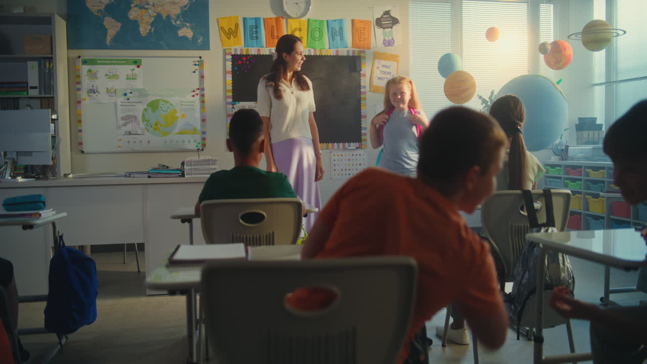 Female Teacher Introducing New Young Pupil in Front of Class Full of Primary School Students