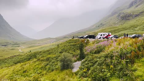 Scottish Highlands on a cloudy day. Distant view of a valley and a stream