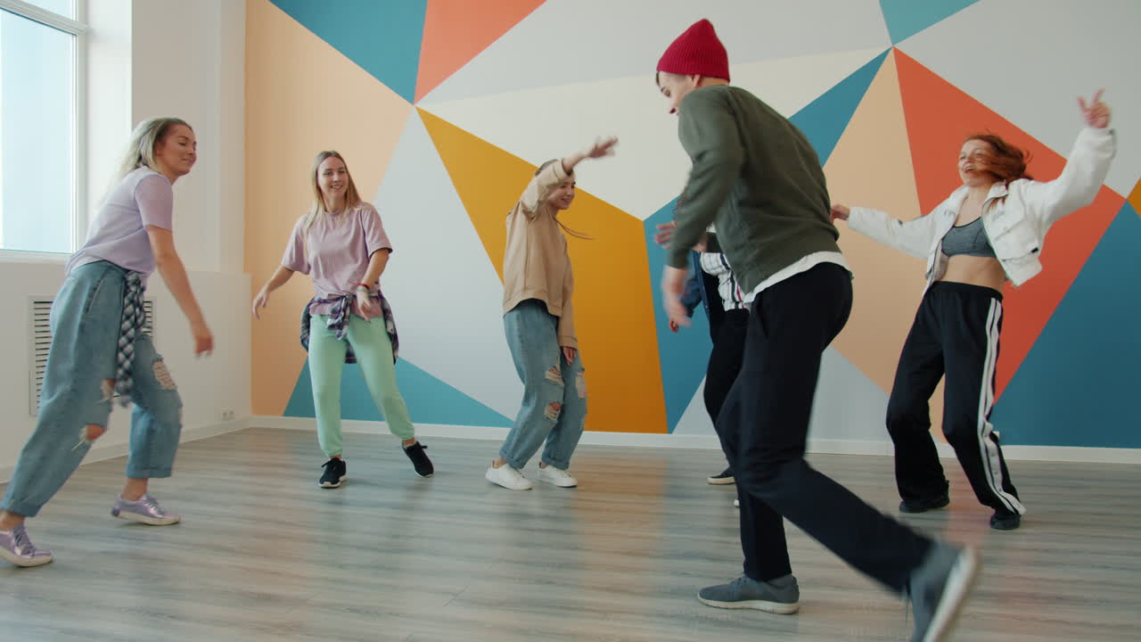 Group of young adults dancing in a vibrant dance studio