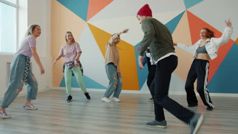 group of young adults dancing in a vibrant dance studio
